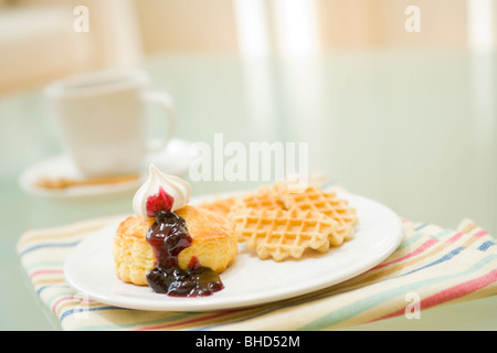 Waffles with blueberry sauce and whipped cream Stock Photo