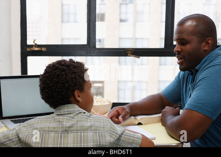 Father and son doing homework Stock Photo