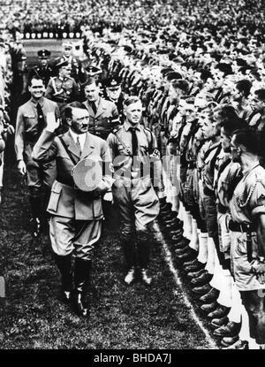 Hitler, Adolf, 20.4.1889 - 30.4.1945, German politician, half length, with Rudolf Hess, Baldur von Schirach, inspecting a formation of Hitler Youth,  at the Nuremberg Rally, 1935, Stock Photo