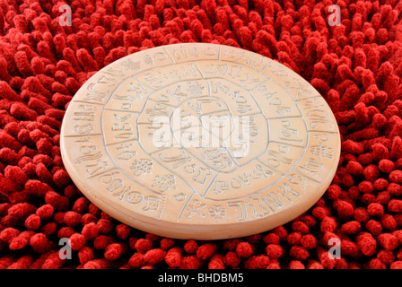 A replica of the Phaistos Disc. The Phaistos Disc is one of the most famous mysteries of archaeology. Many attempts have been ma Stock Photo