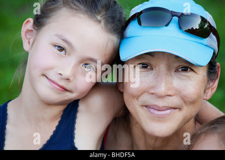 Portrait of happy japanese mother hugging with her cute little daughter