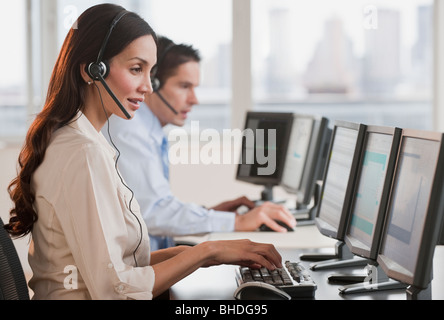 Hispanic businesswoman working on computer Stock Photo