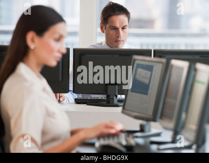 Hispanic businessman working on computer Stock Photo
