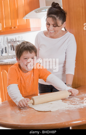 Hispanic mother teaching son to bake Stock Photo