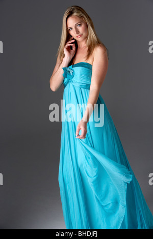 Full Length Studio Shot Of Young Woman In Blue Evening Dress Stock Photo
