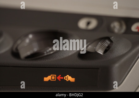 Fasten seat belt sign in an aircraft Stock Photo