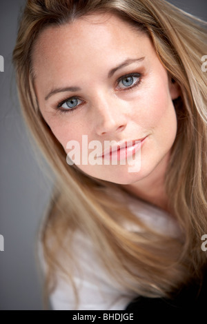 Studio Portrait Of Woman Wearing White Shirt Stock Photo