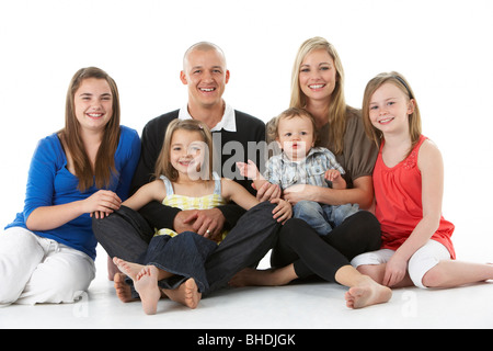 Shot Of Family Group Sitting In Studio Stock Photo
