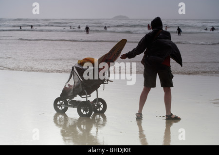 Wet and windy British beach in Summer, Polzeath, Cornwall, UK Stock Photo