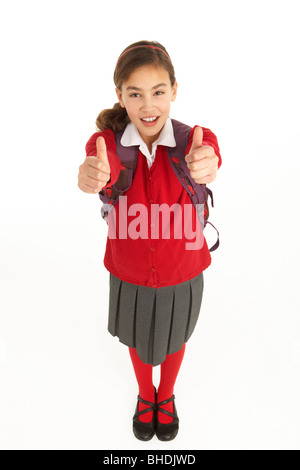 Studio Portrait Of Female Student In Uniform With Backpack Stock Photo