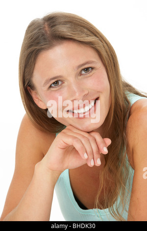 Studio Portrait Of Smiling Young Woman Stock Photo