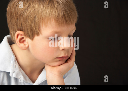 Studio Portrait Of Thoughtful Young Boy Stock Photo