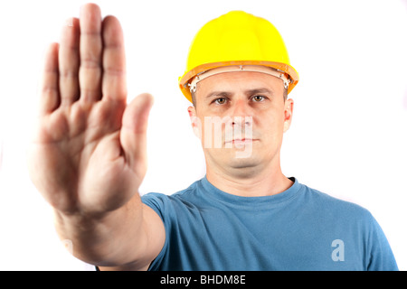 Blue collar worker making a stop sign, isolated on white background Stock Photo