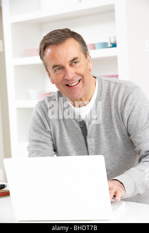 Senior Man Using Laptop At Home Stock Photo