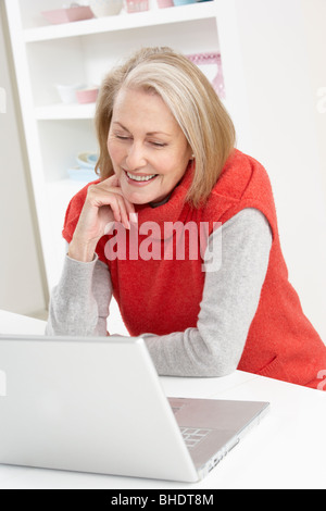 Senior Woman Using Laptop At Home Stock Photo