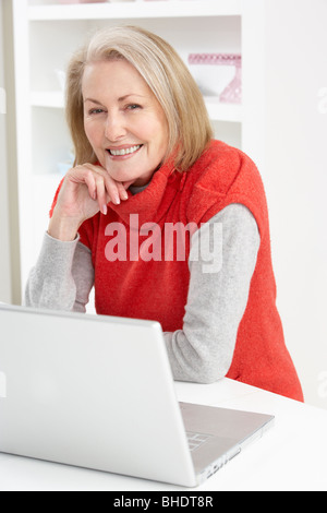 Senior Woman Using Laptop At Home Stock Photo