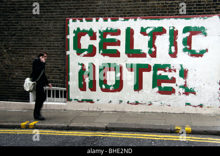 Man on mobile phone walking past the Celtic Hotel in Russel Square, London Stock Photo
