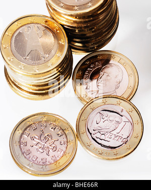 Euro coins from Greece, Portugal and Spain beside piles from Germany Stock Photo