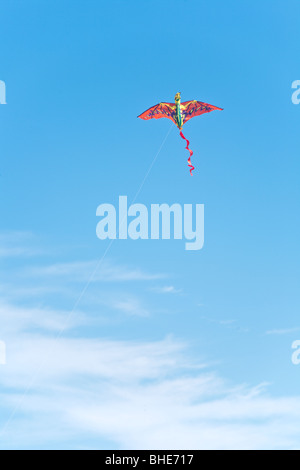 Cape Canaveral, FL - Nov 2008 - Bright red and orange dragon kite flying in blue sky at Jetty Park in Cape Canaveral, Florida Stock Photo