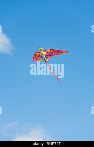 Cape Canaveral, FL - Nov 2008 - Bright red and orange dragon kite flying in blue sky at Jetty Park in Cape Canaveral, Florida Stock Photo