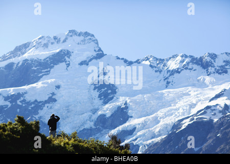 Hiker on Aoraki / Mount Cook National Park on the Hooker Track in Summer - Southern Alps South Island, New Zealand Stock Photo