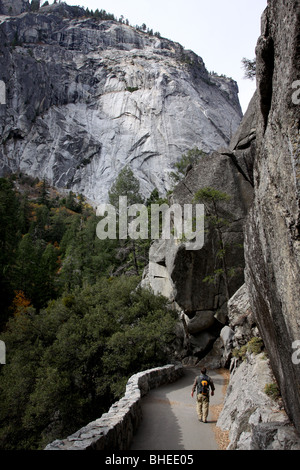 Hiker Vernal Falls trail Yosemite National Park waterfall California Sierra Nevada mountain granite person tree cliff person peo Stock Photo