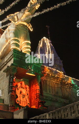 Hindu temples and statues of gods lit by strings of lights at night at the Jagdish Temple in Udaipur during Diwali festival. Stock Photo