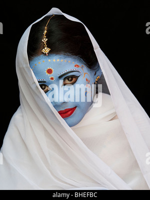 Indian girl, face painted as the Hindu goddess Sita against a black background. India Stock Photo