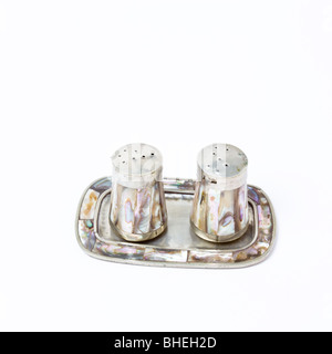 Silver and mother of pearl salt and pepper cruet set. Stock Photo