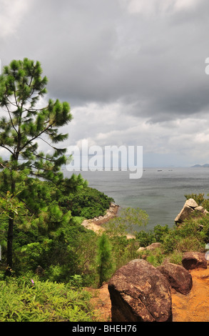 Dark cloud South China Sea portrait, pine tree, red soil, granite on the cliff top, near Ling So Shing, Lamma Island, Hong Kong Stock Photo