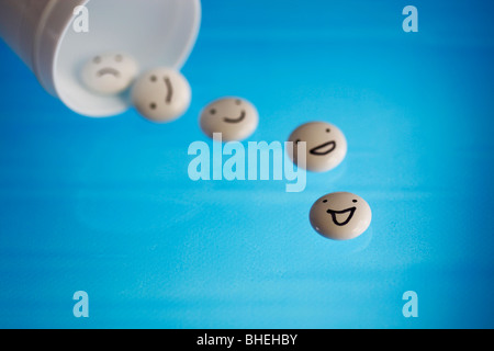 White tablets with mood faces on blue background. Stock Photo