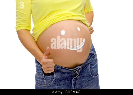 Pregnant woman shows a smiley on her belly, OK sign Stock Photo