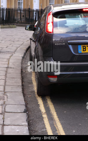 Car parked on double yellow lines no parking Stock Photo