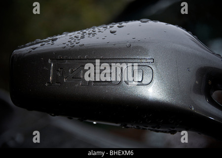 Drivers door mirror of a 2007 Ferrari F430 Spyder in metallic grey. Stock Photo