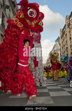 Paris, France, Large Crowd People, Asian Teen, Chinese New Year, Street Carnival, Parade, Performing traditional 'Chinese Dragon Dance' in the Marais, dragons Stock Photo