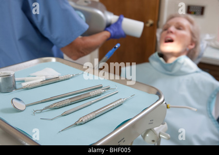 Dental equipment with a female dentist examining a patient Stock Photo