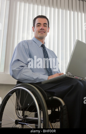 Handicapped businessman working on a laptop Stock Photo