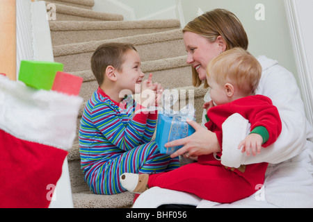 Boy signing the word 'Present' in American Sign Language while communicating with his mother Stock Photo