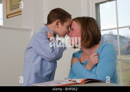 Woman signing the word 'love' in American Sign Language while communicating with her son Stock Photo