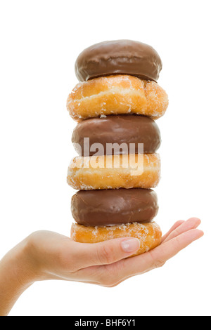 Woman's hand with a stack of delicious doughnuts isolated over a pure white background in studio Stock Photo