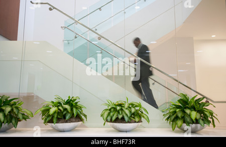 African American businessman ascending staircase Stock Photo