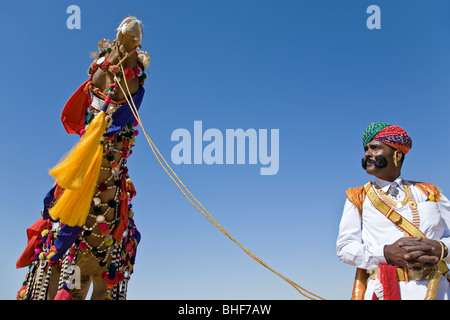 Man and his decorated camel. Jaisalmer Desert festival. Rajasthan. India Stock Photo
