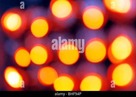 Diffused, out of focus, orange lights on electronic equipment Stock Photo