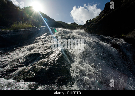 Waterfall in the mountains in the sunlight, , Barranco del Charco Azul, El Risco valley, Parque Natural de Tamadaba, Gran Canari Stock Photo