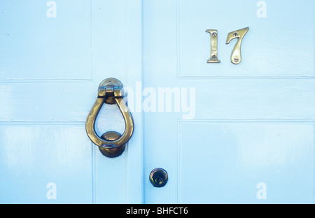 Detail of stylish white painted Georgian front door with brass number 17 and knocker Stock Photo