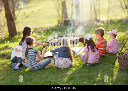 Children barbecueing sausages, Munsing, Bavaria, Germany Stock Photo