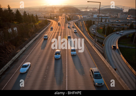 From the 12th Street Bridge in Seattle, Washington, commuter traffic heads east on the I-90 freeway. Safeco Field/Qwest Field. Stock Photo