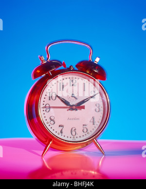 Alarm clock on pink base Stock Photo