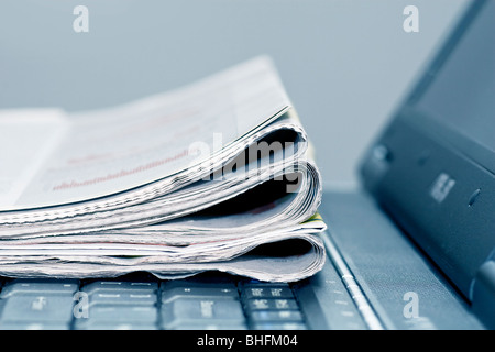 newspapers on the laptop Stock Photo