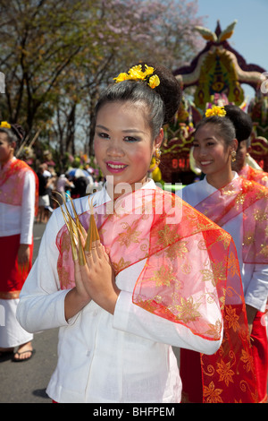 Wai buddhist greeting, respect, culture Thai cultural female asian woman dancer, portrait, traditional, flower art, clasped hand gesture Thailand. Stock Photo